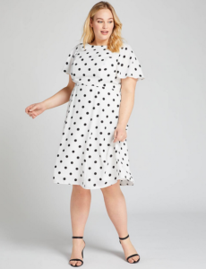 Woman wearing white dress with black polka dots